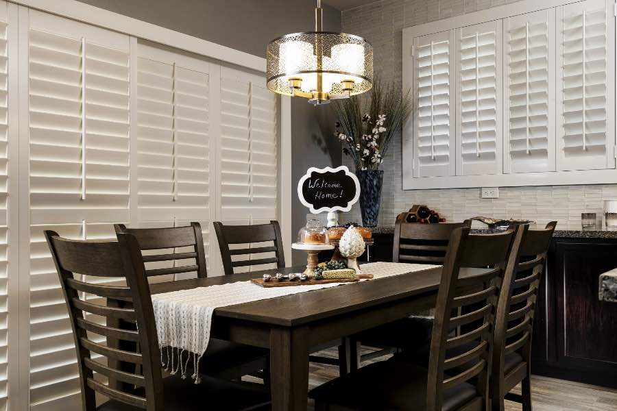 Polywood shutters on a sliding door and window in a dining room